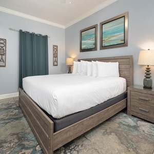 Inviting guest bedroom featuring a king bed, stylish decor, and a TV for your entertainment