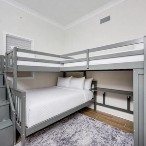 Charming guest room featuring a twin bunk bed and a cozy lower double bed, perfect for family stays