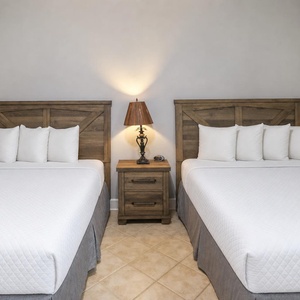 Warm light creates the perfect retreat for restful nights in this cozy queen guest suite