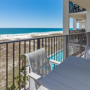 Balcony seating offers a serene view of the white sand beach and the sparkling gulf, perfect for relaxation