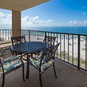 Relax on the balcony with a round table and chairs, enjoying the beautiful beach view and gentle sea breeze