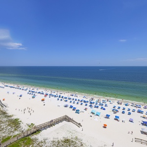 Experience breathtaking views of the pristine beach and vibrant umbrellas from your private balcony, perfect for relaxation