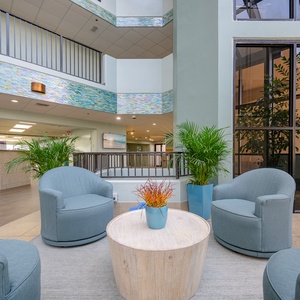 Relax in this inviting lounge with beach views, comfortable seating, and a cozy atmosphere perfect for unwinding