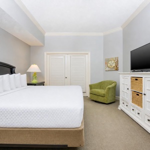 Sink into the plush comfort of the king master suite, ready to unwind and catch up on your favorite shows