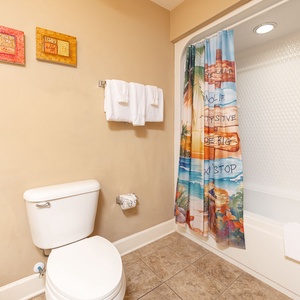 Enjoy refreshing moments in this guest bath, surrounded by soft towels and vibrant decor that energizes your routine