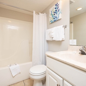 Refresh in this bathroom featuring a spacious tub-shower, modern sink, and soft towels for your comfort