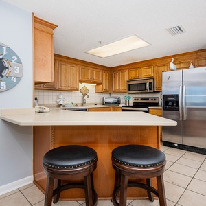 Prepare meals at the spacious kitchen, featuring stainless appliances and inviting seating for casual dining