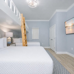Inviting bunk room, perfect for families, with two lofted bunk twins over cozy queen beds
