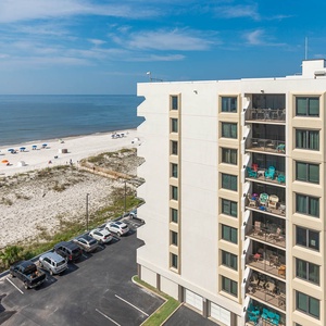 Relax with breathtaking beach views from this inviting balcony, perfect for relaxation and soaking up the sun
