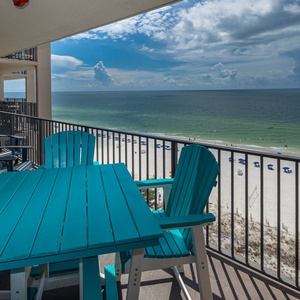 Relax on the balcony with vibrant chairs and stunning views of the beach and tranquil gulf waters