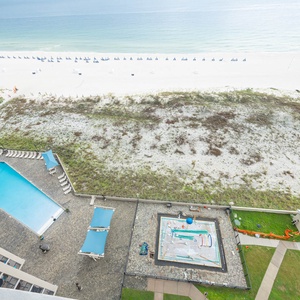 Relax by the gradual entry pool, enjoying the inviting splash play area and easy access to the beach just steps away