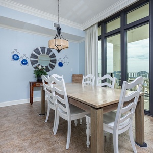 Gather around the dining table, sharing laughter and stories while enjoying the inviting beach vibe just steps away