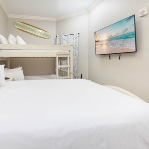 Rest peacefully in the queen bed, with a cozy full over full bunk nearby, perfect for creating joyful memories together