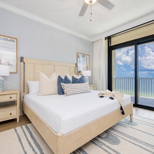 Unwind in this serene master bedroom featuring a king bed, coastal decor, and beachfront balcony access