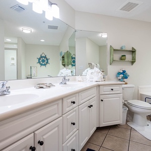 Indulge in serenity as you unwind in the soothing ambiance of this master bath with a jetted tub and glass shower