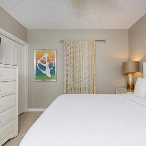 A guest suite with a queen bed offers restful comfort and coastal-inspired art to calm your spirit at day's end