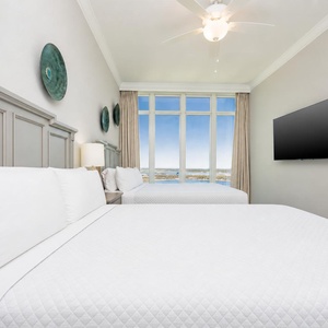 Lie back on comfortable queen beds, feel the fan's breeze, and watch the coast through large windows