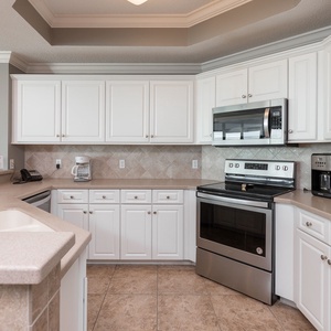 Prepare your favorite meals with ease in this kitchen, featuring stainless appliances and stylish cabinetry