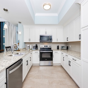 Cook and gather in this kitchen, featuring a spacious countertop and stainless appliances