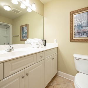 Revitalize with a refreshing shower in this guest bath, surrounded by serene decor and ample natural light