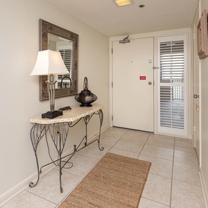 Step into a welcoming entryway featuring a stylish console table, lamp, and a mirror that enhances the space