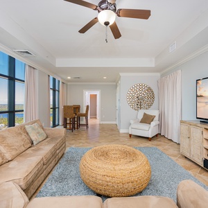 Sink into the plush sofa, sharing laughter and stories with loved ones as you enjoy the inviting coastal vibe