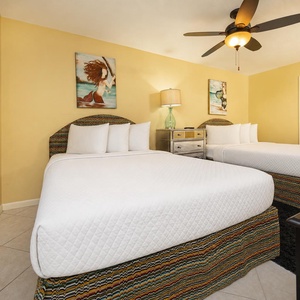 Relax in this guest bedroom featuring two queen beds, vibrant decor, and a welcoming vibe for restful nights