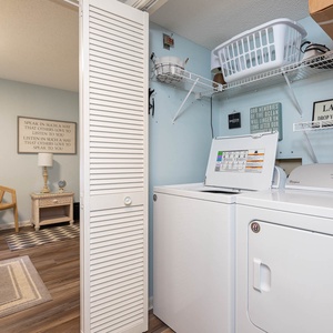 Discover a convenient laundry area featuring modern appliances and a cozy seating nook for relaxation