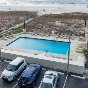 Enjoy a refreshing view of the pool area and beach from this inviting space, perfect for relaxation and fun