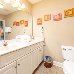 Refresh with soft towels in this guest bath, enjoying vibrant decor that adds a cheerful vibe to your routine