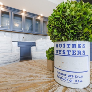 Admire coastal decor and enjoy a drink at the inviting table, surrounded by warmth and stylish comfort