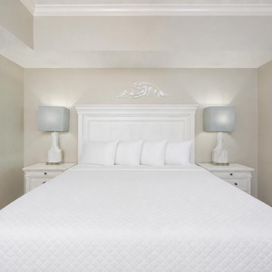 Unwind after a day at the beach in this elegant king master suite surrounded by stylish coastal accents