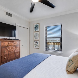 Inviting guest bedroom featuring a large queen bed, stylish decor, and a view from the window