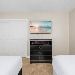 Enjoy movie nights in this guest room, with coastal art adding charm while you unwind and relax together