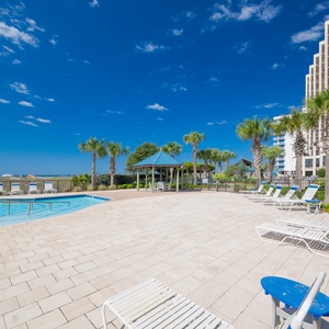 Enjoy a relaxing day in the sun on the outdoor patio with the pool and beach just steps away