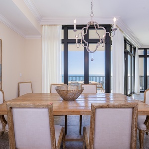 Gather your family around the rustic dining table, while enjoying the inviting vibe and coastal views through large windows