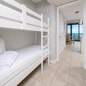 This cozy nook features two bunk beds, perfect for kids, with fresh linens and easy access to the inviting living area