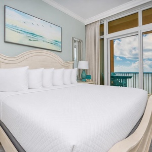 Experience restful nights in this inviting master bedroom, featuring a king bed and beach balcony views