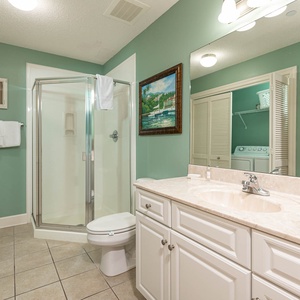 Refresh in this additional guest bath with a walk-in shower and laundry area with a washer and dryer in your rental
