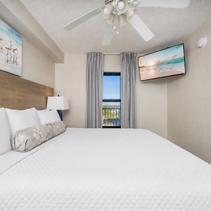 Fluffy pillows invite you to relax in the king suite for a calm movie night after a fun day at the beach