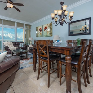 Gather around the elegant dining table or relax on the plush seating while enjoying the beautiful beachfront views