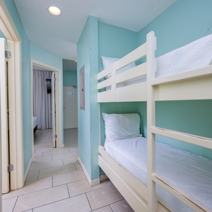 Cheerful hallway nook with bunk beds, perfect for kids, and a calming teal hue that invites relaxation