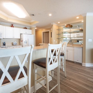 Gather at the stylish breakfast bar, sipping morning coffee in a bright space filled with coastal charm