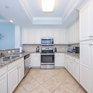 White cabinets shine under soft light as you prepare fresh meals and gather around the breakfast bar in the kitchen