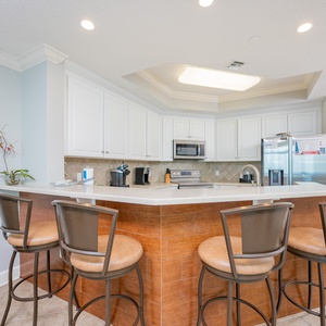 Enjoy morning coffee at the breakfast bar, soaking in the cozy kitchen vibe while planning your beach day