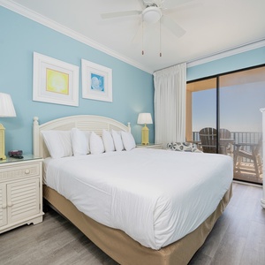 Light blue walls complement the inviting king bed in the master, with balcony access offering a view of the beach