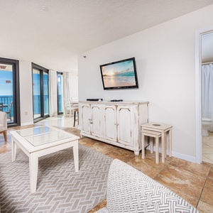 Relax in the inviting living area with plush seating and a large TV, perfect for unwinding after a day of fun