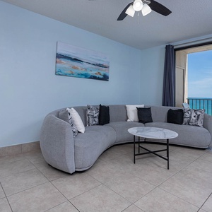Unwind on the sleek sofa, enjoying the serene beach views through large windows that invite in natural light