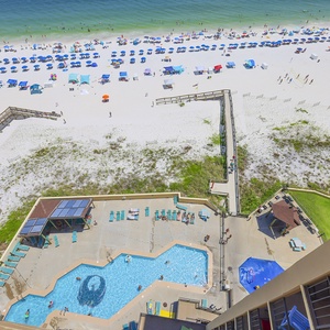 Enjoy breathtaking views of the beach and a sparkling pool from your private balcony, perfect for relaxation and fun