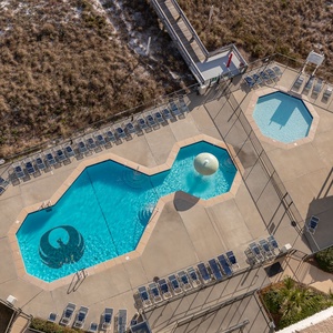 Aerial view of the pool area featuring a spacious pool, mushroom fountain, kiddie pool, and lounge chairs